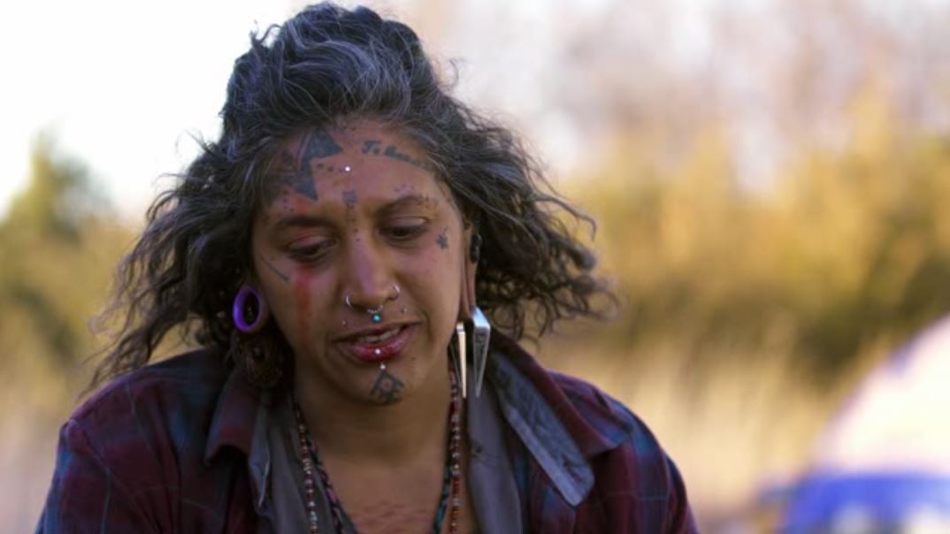 The meme is a photo of a woman with a strong, stoic expression, likely a Native American woman. She has a few tattoos and piercings, and her hair is styled in a way that's both messy and elegant. The text "I survived the Trail of Tears, I can handle your 30 minutes of wifi downtime" is written above or below the image, implying that the woman's tough past makes her able to handle minor frustrations.